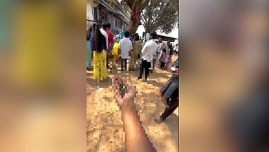 Image shows a blurred hand holding ganja infront of a Shiva idol in Hyderabad
