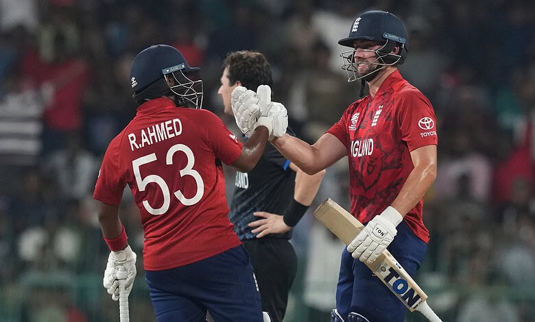 England cricketers R. Ahmed and Rehan celebrate a key wicket in T20 World Cup.