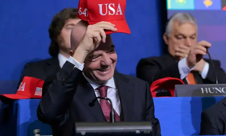 American delegate smiling and adjusting his red USA cap during a formal event.