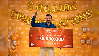 Indian expat Murugananth Govinthan holds cheque after winning Dh 5 million UAE Lottery