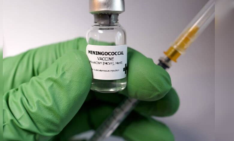 Close-up of meningitis vaccine vial and syringe for Umrah pilgrims' health safety.