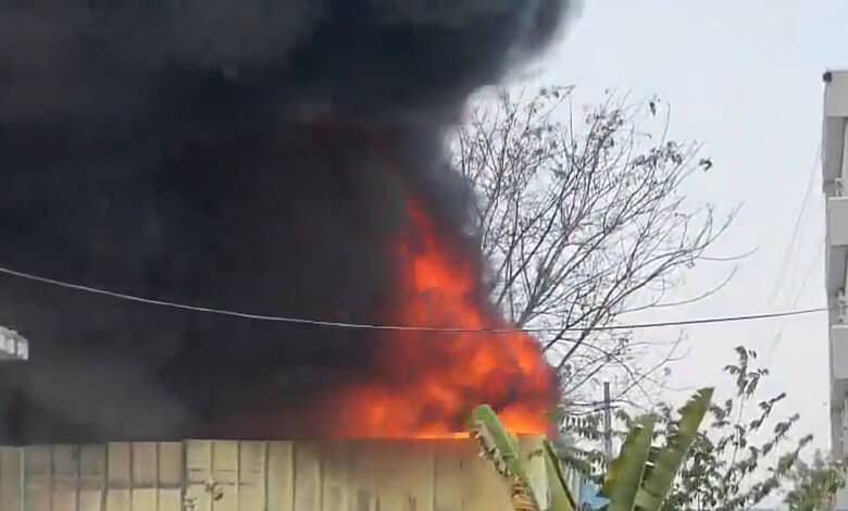 Fire erupts at Sangareddy warehouse causing thick smoke and flames.