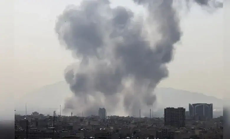 Smoke billows over Tehran skyline after reported US-Israeli airstrikes.
