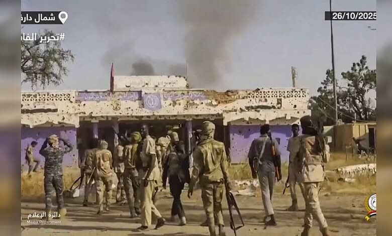 An image showing armed personnel and smoke rising from buildings amid ongoing violence in Sudan.