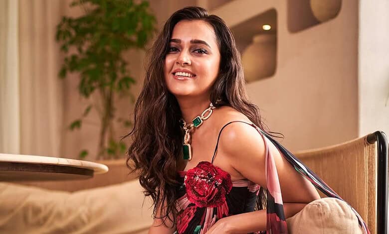 Tejasswi Prakash smiling in her elegant living room, showcasing her Rs 7 crore new home.