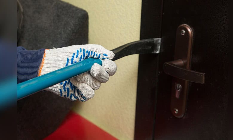 Man being arrested for stealing two mobile phones from a door lock.