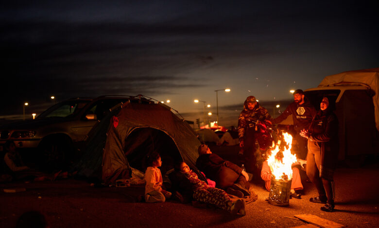 Members of a family, who fled Israeli strikes in southern Lebanon, sit around a bonfire outside a tent used as a shelter in Beirut, Lebanon, Wednesday, March 25, 2026. AP/PTI(AP03_26_2026_000313B)