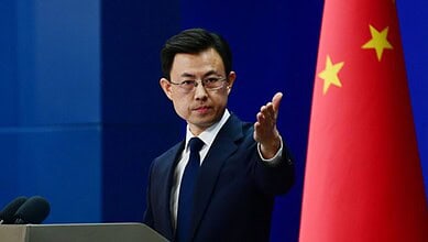 Chinese official announces USD 200K aid for victims of Iranian school bombing at press conference.