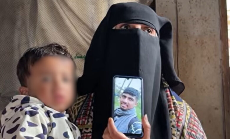 Holding her grandson Jawad, Rana shows a picture of Osama Abu Nassar, both of whom were detained by Israeli forces.