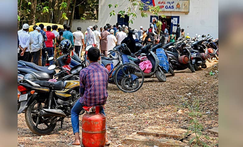 People waiting in line for LPG cylinders during fuel shortage.