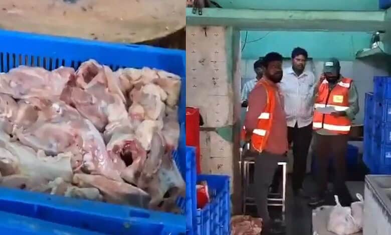 Close-up of raw chicken pieces in crates at Siasat Daily.