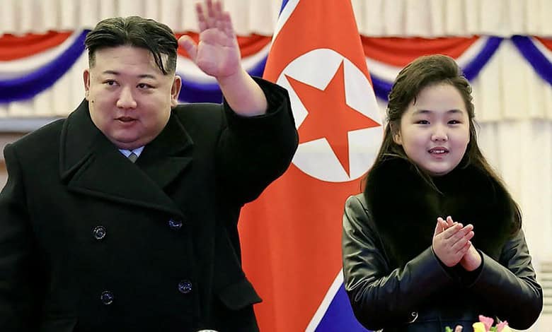 North Korean leader Kim Jong-un and his daughter attending a missile test event with North Korean flags i.