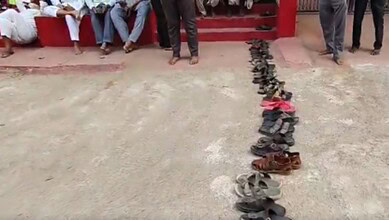 Queue of residents leaving footwear in line for LPG cylinders in Bhainsa, Telangana.