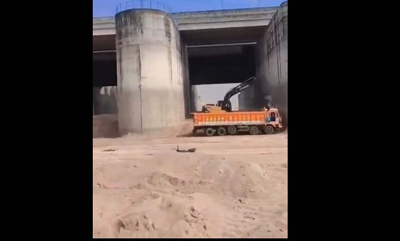 Heavy machinery engaged in sand mining under Telangana's Annaram barrage.