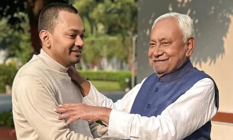 Bihar politicians engaging in a friendly outdoor discussion, reflecting political developments.
