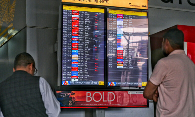 Passengers look at the display board for information amid the ongoing conflict in the Middle East, at Indira Gandhi International Airport, in New Delhi, Tuesday, March 3, 2026. (Source PTI)