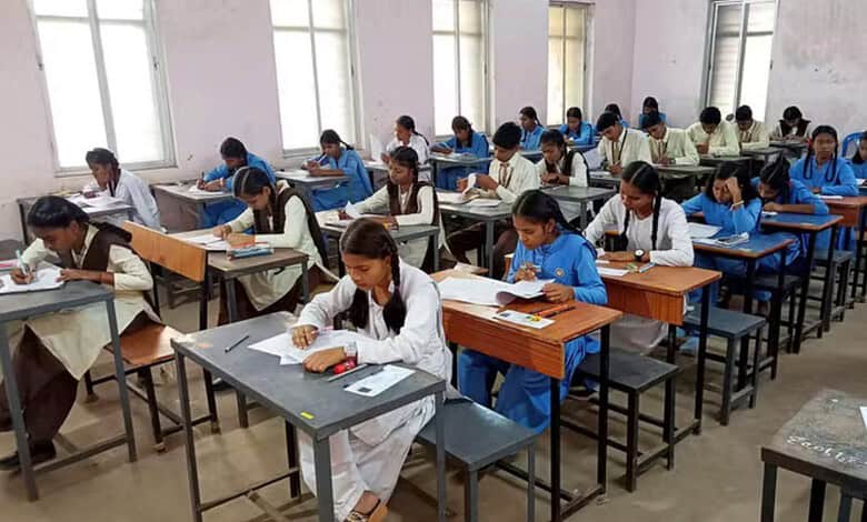 Students taking Telangana SSC exams with OMR sheets in a classroom setting.