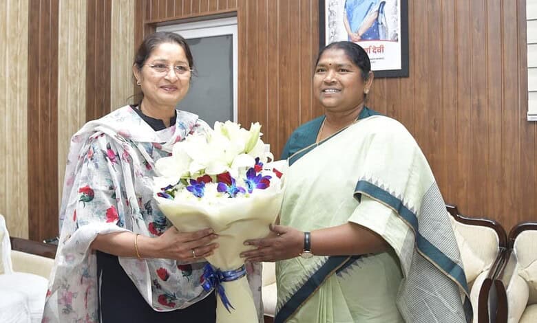 Telangana minister Seethakka with a woman holding a bouquet, advocating for higher wages for crèche worke.