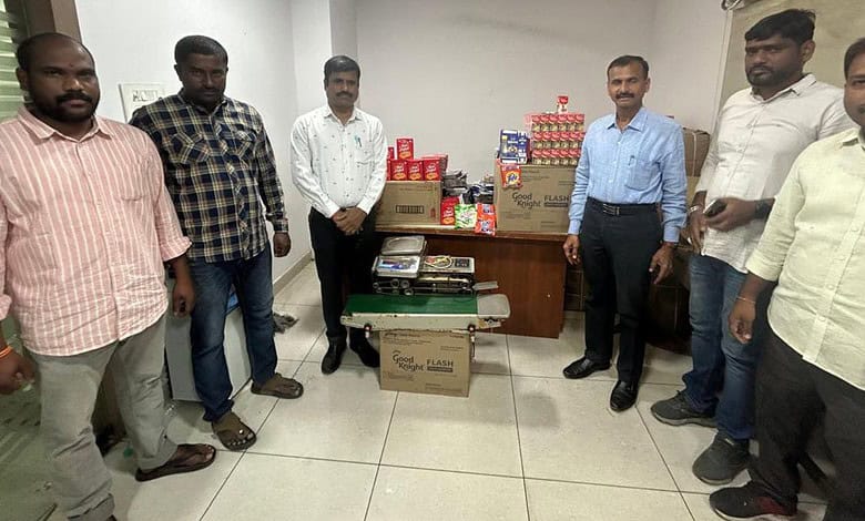 Hyderabad police display seized packets of counterfeit tea and detergent.