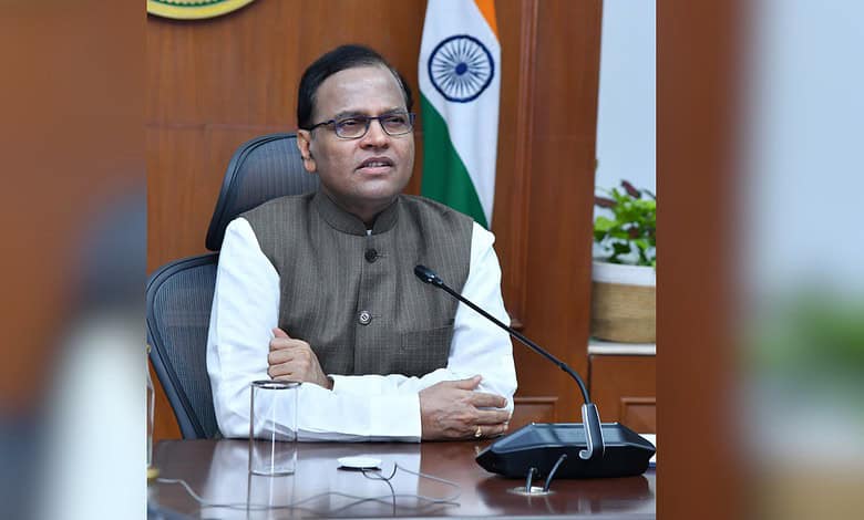 Telangana Chief Secretary seated at desk with Indian flag, discussing digital dashboard for tracking inve.