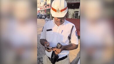 Traffic police officer in uniform using a mobile phone during duty.