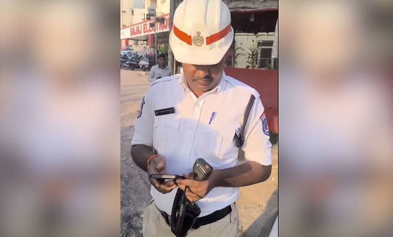 Traffic police officer in uniform using a mobile phone during duty.