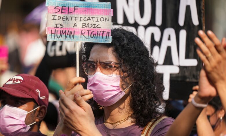 A member of the LGBTQIA+ community holds a placard during a protest against the passage of the Transgender Persons (Protection of Rights) Amendment Bill, 2026, in Parliament, at Azad Maidan in Mumbai on Wednesday, March 25.
