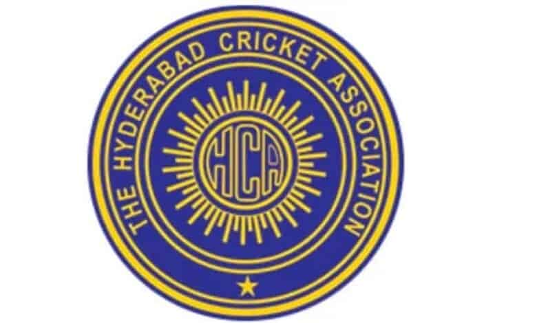 Hyderabad Cricket Association emblem with HCA initials and sunburst design.
