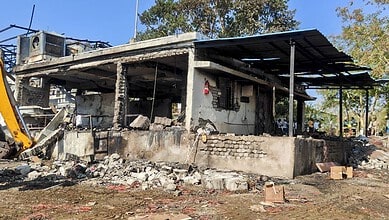 Damaged factory building in Nagpur following a tragic blast, with debris and destruction visible.