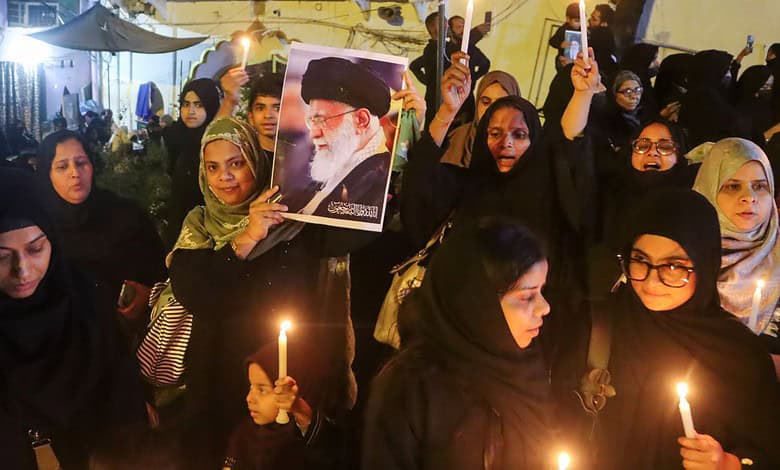 Crowd of women protesting with candles and photos, heightened security in Delhi following recent unrest.