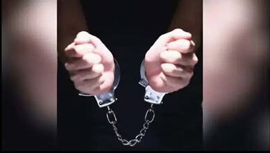 Hands in handcuffs, symbolising arrest and detention.