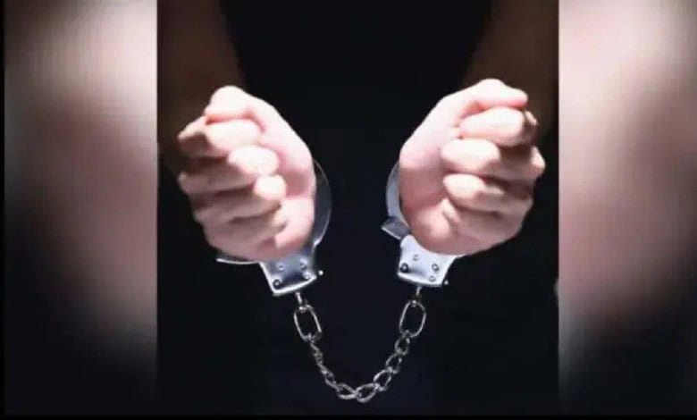 Hands in handcuffs, symbolising arrest and detention.