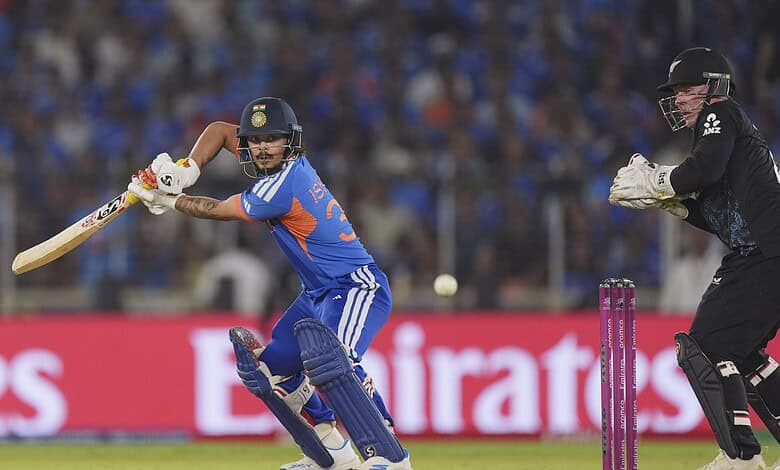 Cricket player batting with a bat while the wicketkeeper prepares behind the stumps during a match.