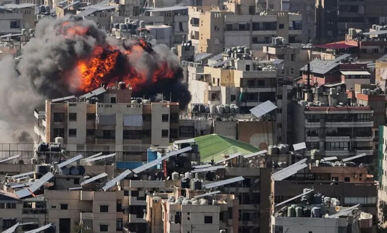 Explosion in Tehran cityscape with smoke and fire amid urban buildings.