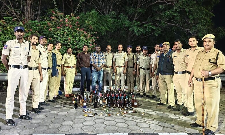 Telangana excise officials with seized liquor bottles