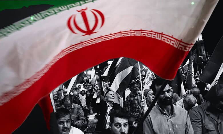 Iranian protesters waving flags in a defiant rally against US and Israel.