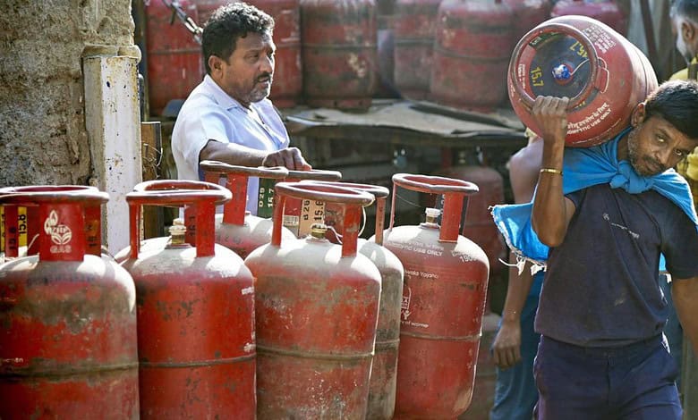 Man carrying LPG cylinder during panic buying amid Middle East conflict in Bengaluru.