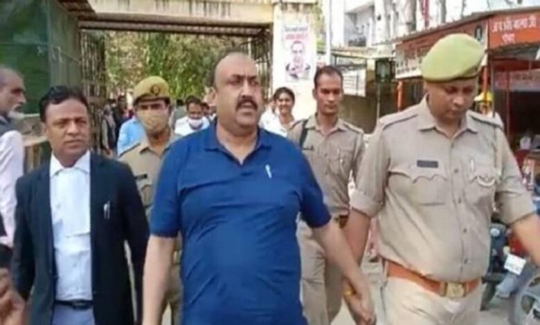 SP leader Yusuf Malik escorted by the police