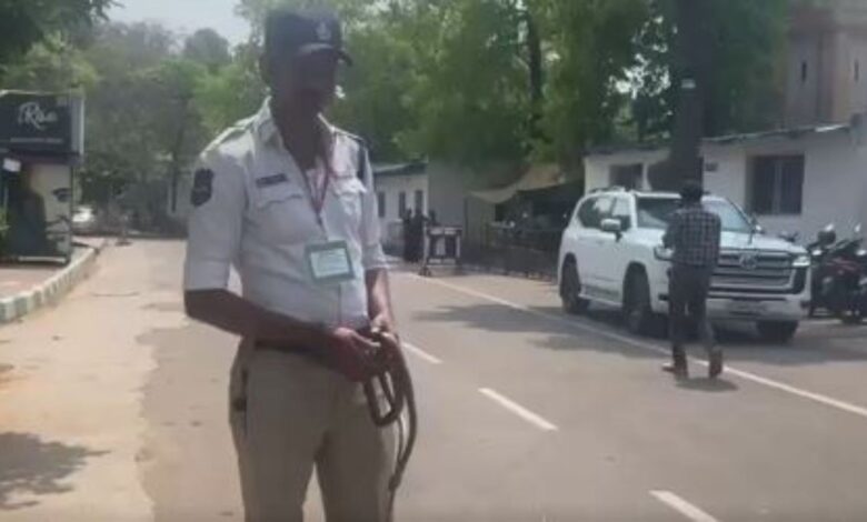 Traffic constable holds the snake found on Telangana Assembly