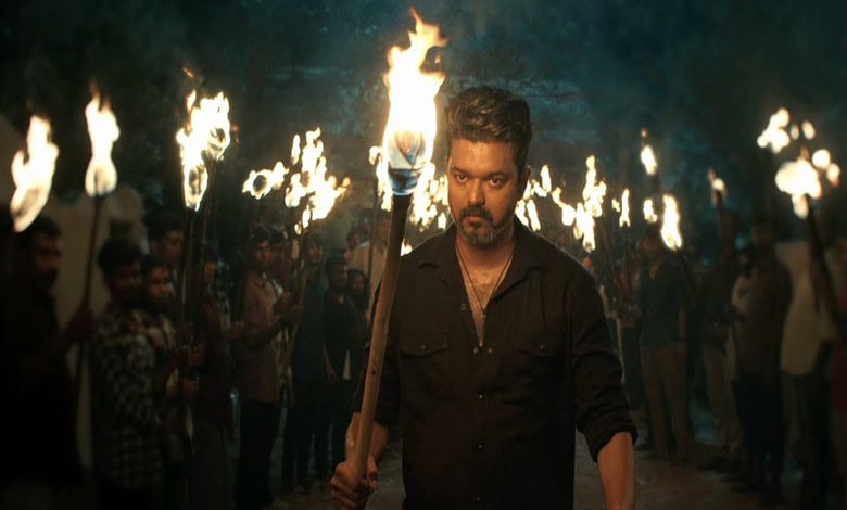 Vijay leads a torchlight march to address rumours, surrounded by supporters holding torches at night.