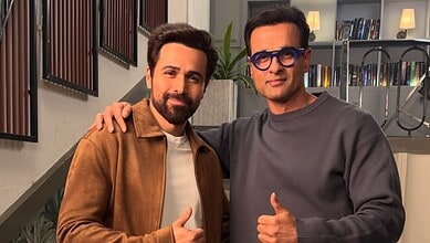 Rohit Roy and Emraan Hashmi posing together, smiling, in a modern indoor setting.