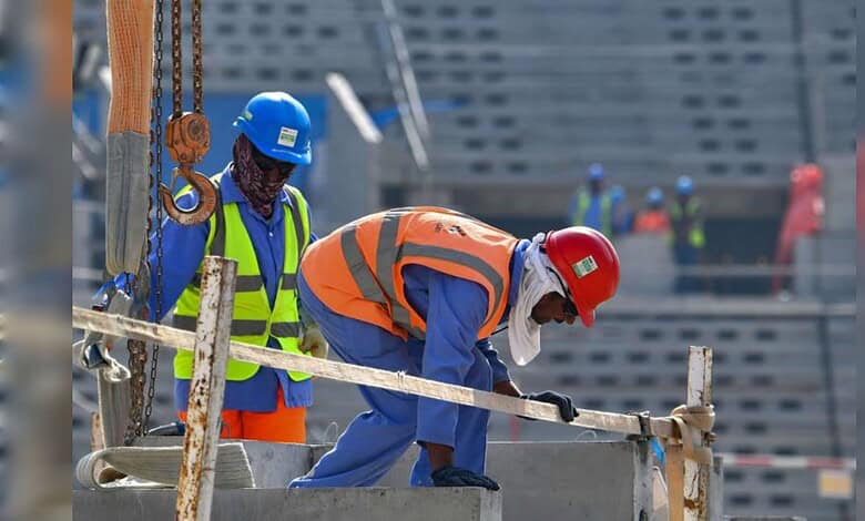 Workers on construction sites in Oman, wearing safety gear and helmets, involved in building infrastructu.