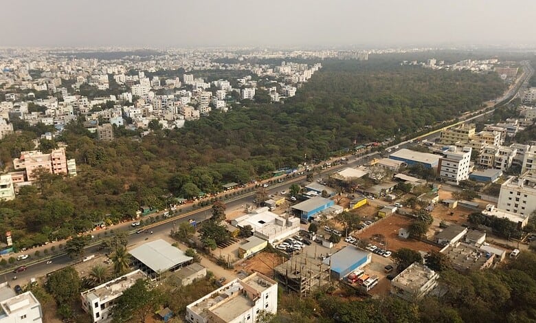 This image shows the Gurramguda region in Telangana, recently declared a reserve forest, with urban development and lush greenery visible from above.