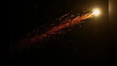 Bright missile trail in the night sky over Jerusalem during an Iranian missile launch towards Israel.
