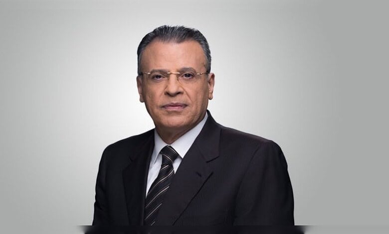 Jamal Rayyan, veteran Al Jazeera journalist, in a formal portrait wearing a suit and tie.