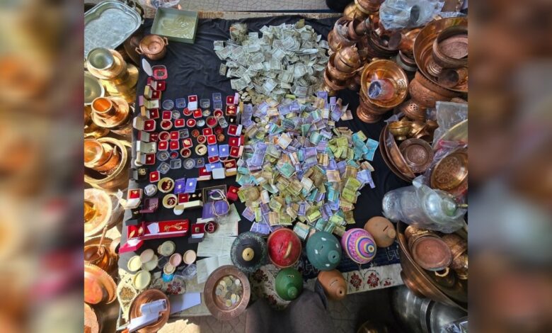 Pile of cash, jewellery and copper utensils collected as donations in Kashmir for Iran relief.