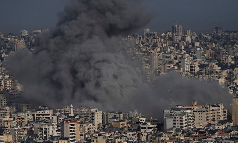 Explosion and smoke over a city skyline during ongoing conflict.