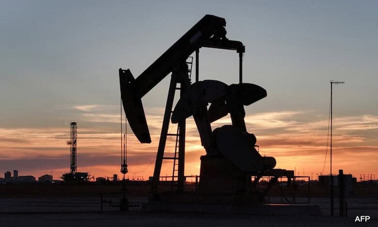 Oil pumpjack silhouetted against a sunset sky, highlighting energy sector impacts amid rising oil prices.