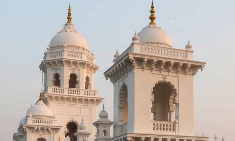 The restored historic Town Hall with white façade and ornate domes, now serving as the Legislative Counci.