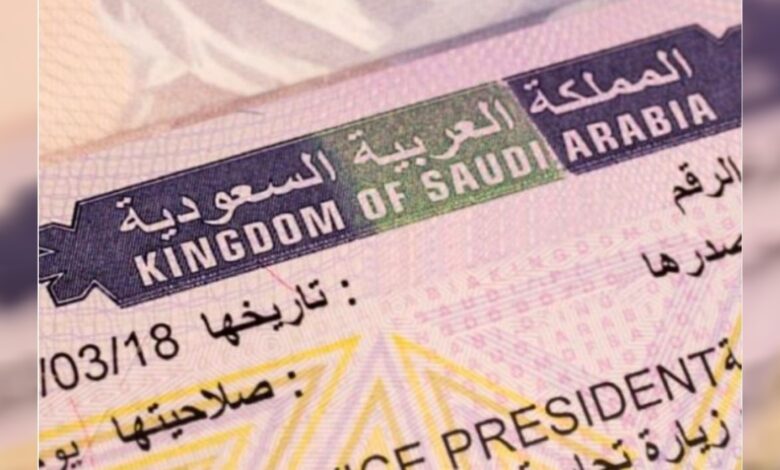 Close-up of a Saudi Arabia residency visa showing Arabic and English text and official markings.